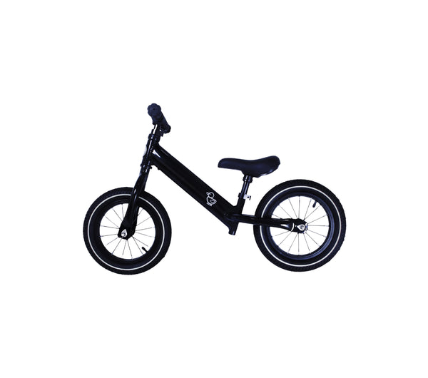 black balance bike with white wall tyres